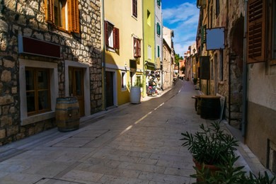 old stone street with nice quiet shops and old oak wine drums in scradin town in the autumn in croatia