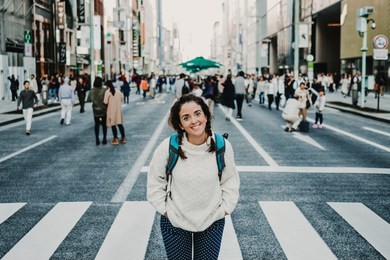 caucasian middle-aged woman traveling through japan. touring the city of tokyo in one of the neighborhoods with more shops. lifestyle.