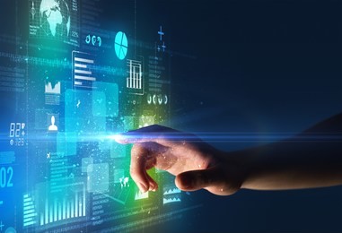 female finger touching a beam of light surrounded by blue and green data and charts