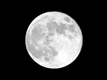 full moon over dark black sky at night