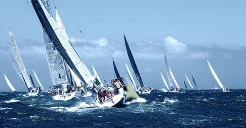 sailboat under white sails at the regatta. sailing yacht race