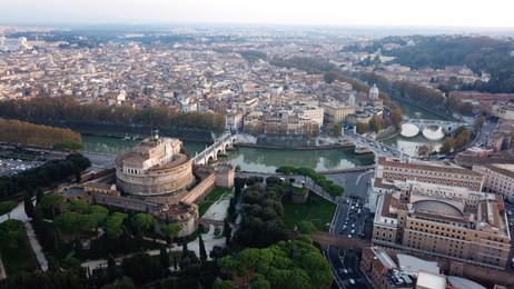 aerial drone view of iconic castel sant' angelo (castle of holy angel) and ponte or bridge sant'angelo with statues in river of tiber next to famous vatican, rome, italy