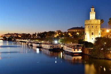 torre del oro (gold tower) and river rio guadalquivir at night, seville, andalusia, spain, europe