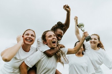 female football players celebrating their victory