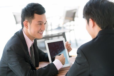 joyful businessman presenting optimal business solutions to his partner