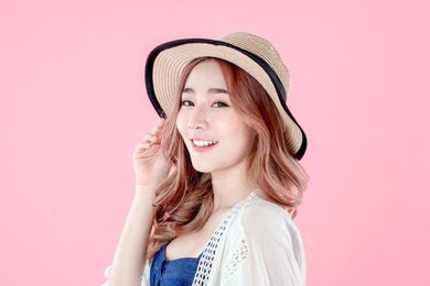 asian woman tourist happy vacation, summer holiday clothing, pink background