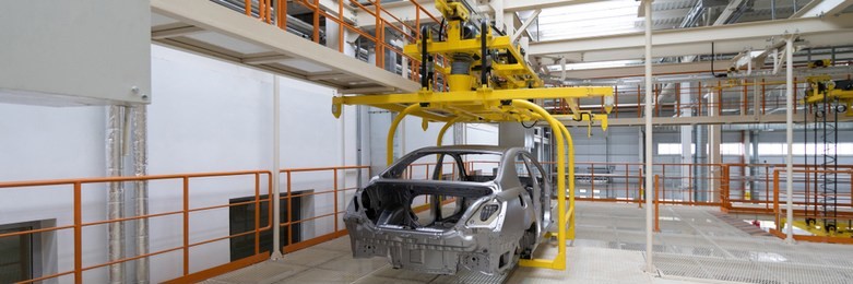 body of car on conveyor close-up. automotive production line. long format. wide frame