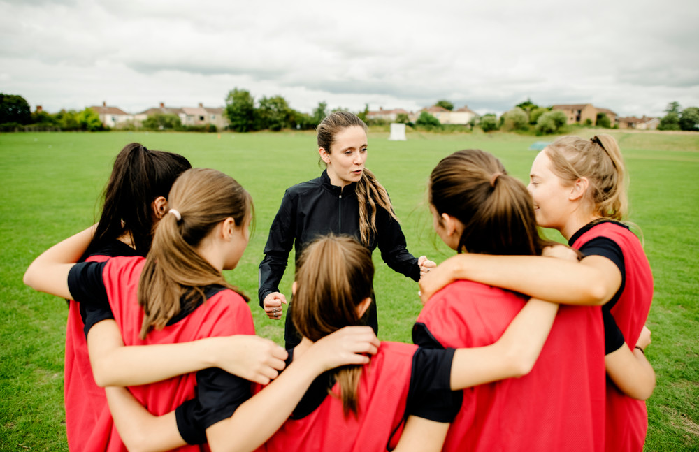 rugby players and their coach gathering before a match
