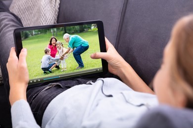 close-up of a girl's hand watching video on digital tablet