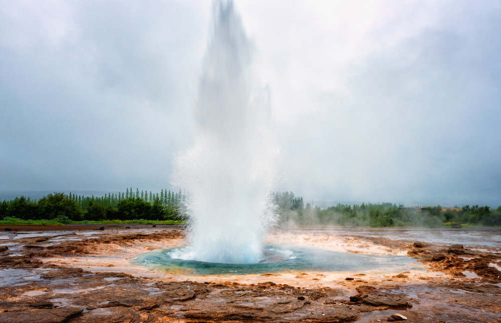 magnificent strokkur geyser erupts the fountain of azure water, popular tourist attraction, haukadalur geothermal area, iceland