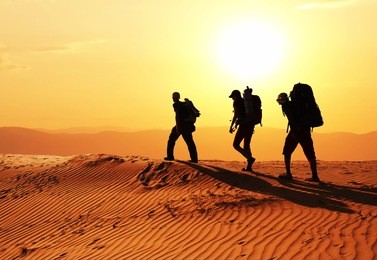 men in sand desert