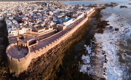 aerial panorama of medieval essaouira old city on atlantic coast at sunset, morocco