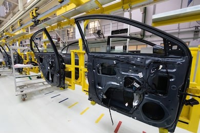 car door on conveyor. robotic equipment makes assembly of car. modern car assembly at factory