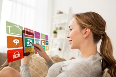 automation, internet of things and technology concept - woman with tablet computer and virtual projection of smart home icons