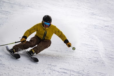 expert skier speeding on groomed run