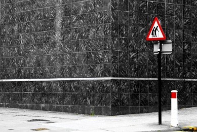 danger senior crossing sign on an empty road corner