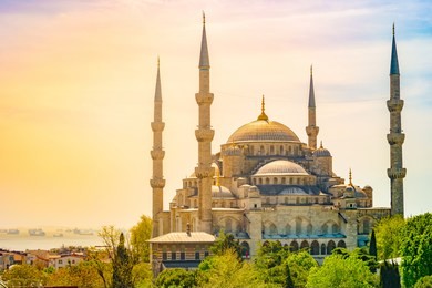 minarets and domes of blue mosque with bosporus and marmara sea in background, istanbul, turkey. beautiful landscape at sunset.