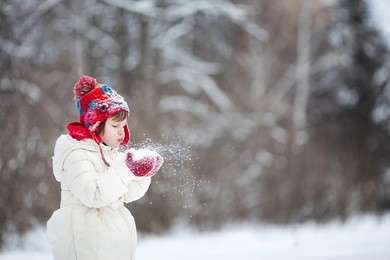 small girl playing with snow