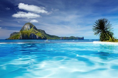landscape with swimming pool and cadlao island on background, el nido, philippines