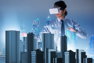 man with virtual reality goggles doing urban planning