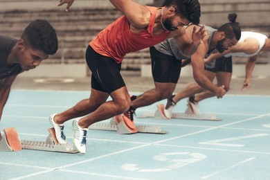 runners using starting blocks to start the race on running track. athletes starting their sprint on a running track with the help of starting blocks.