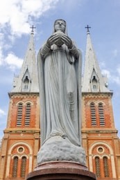 the virgin mary statue and exterior of saigon notre dame cathedral basilica in ho chi minh city, vietnam. asia