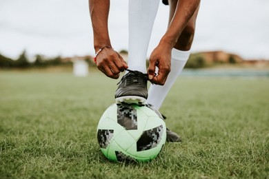 football player tying her shoelaces