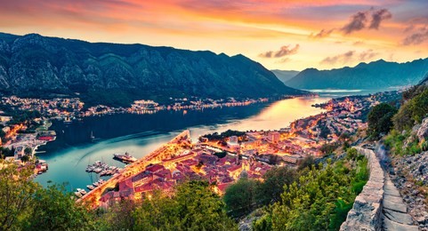 great summer sunset in kotor port. aerial evening view of kotor bay and old town from hill of  lovcen mountain. beautiful world of mediterranean countries. traveling concept background.