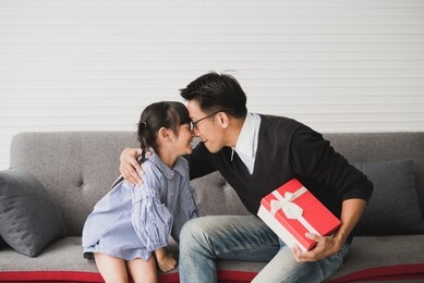 asian father give present for daughter and kiss. concept surprise gift box for birthday.