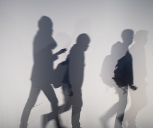 diffused silhouette of people through white cloth
