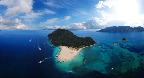 aerial drone panoramic view of iconic small uninhabited island of marathonisi a natural hatchery of caretta-caretta sea turtles, zakynthos island, ionian, greece