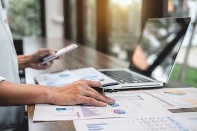 business woman accountant working audit and calculating expense financial annual financial report balance sheet statement, doing finance making notes on paper checking document.