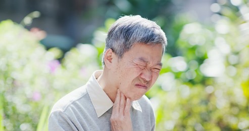 old man get a cold and feel throat pain outdoor or symptom of esophageal cancer
