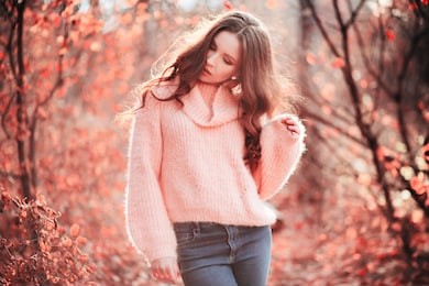 young woman in living coral forest. color of the year 2019. main trend natural and authentic concept.