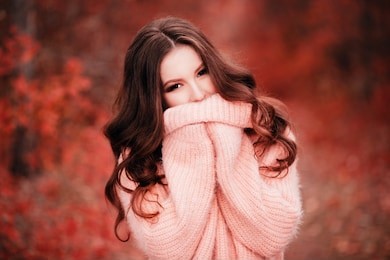 young woman in living coral forest. color of the year 2019. main trend natural and authentic concept.