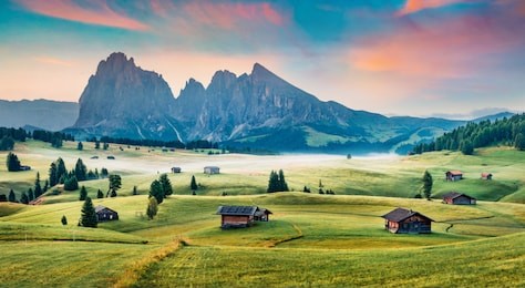breathtaking morning scene of compaccio village, seiser alm or alpe di siusi location, bolzano province, south tyrol, italy, europe. fantastic summer sunrise of dolomiti alps. 