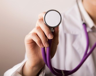 close-up of female doctor using stethoscope , focus on stethoscope