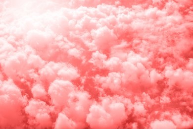 living coral color of the year 2019. aerial view of sky with fluffy clouds. retro toned abstract background.