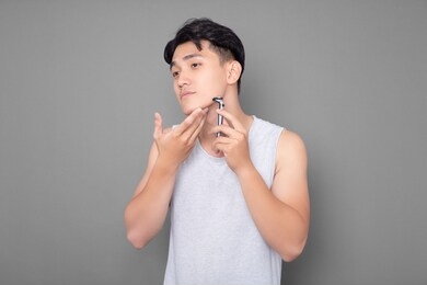 asian man is shaving