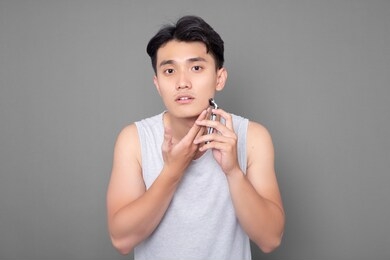 asian man is shaving