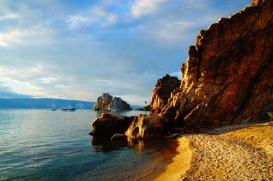 beautiful, small sandy beach with rocks in sunset at olkhon island, baikal lake near irkutsk, buryatia republic, southern siberia, russia, asia