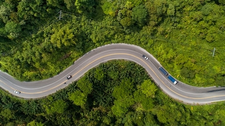 aerial view road curve construction up to mountain 