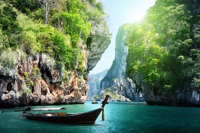 long boat and rocks on railay beach in krabi, thailand