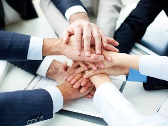 close-up of business partners making pile of hands at meeting