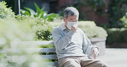 old man wear mask and get a cold and cough outdoor 