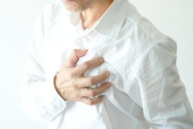 heart attack, man standing chest pain in the bedroom health concept