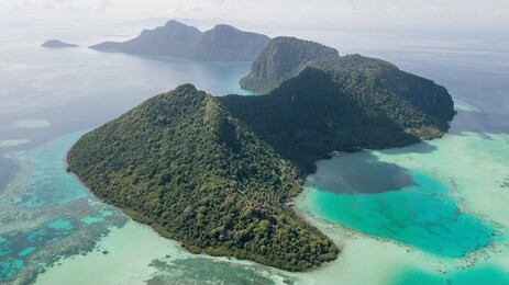 aerial view of bohey dulang island panorama, beautiful blue lagoon and coral reef.