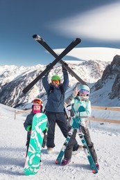 child and mom skiing in the mountains. kid in ski school. winter sport for kids. family christmas vacation in the alps. children learn downhill skiing. alpine ski lesson for boy and girl. outdoor snow