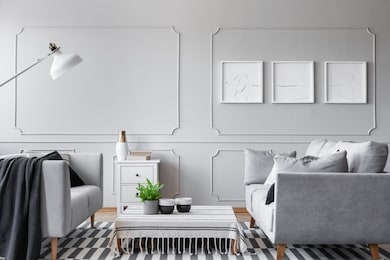 real photo of an elegant living room interior with a low coffee table, sofas and three graphics