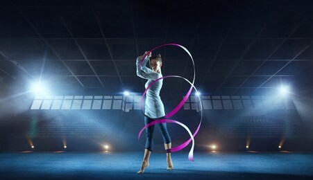 beautiful rhythmic gymnast in professional arena.